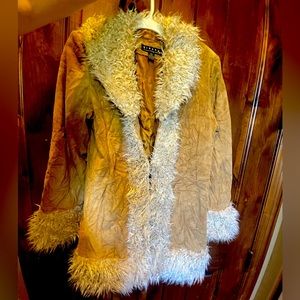 Genuine suede leather coat, hook and eye closure lambs wool trim.